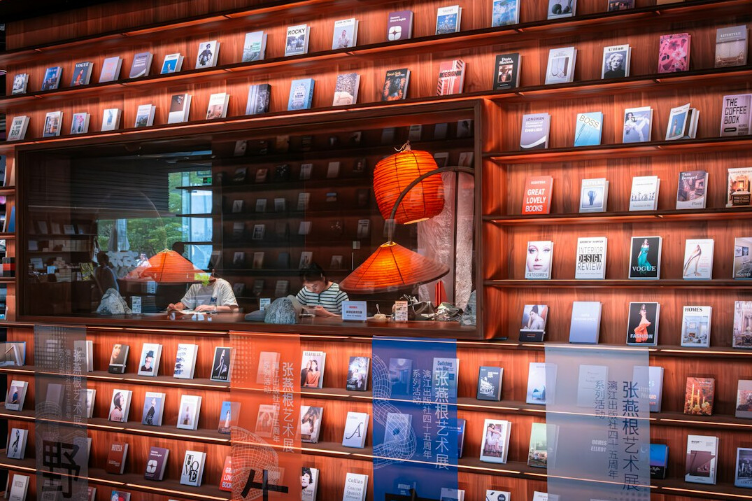 Rows of old books on wooden library shelves